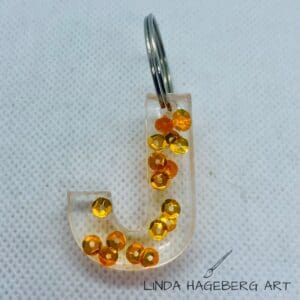 Nøkkelring J, orange paljetter